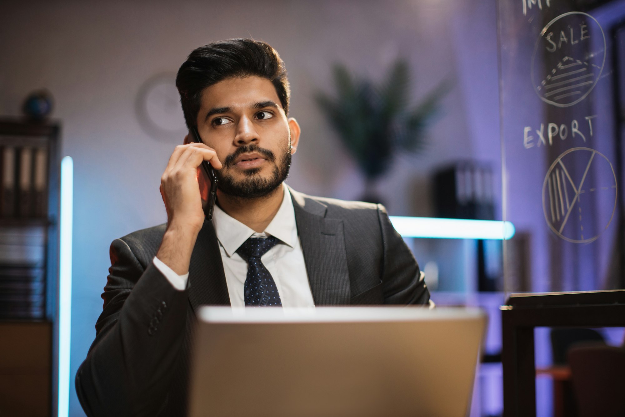Close up portrait of handsome concentrated hardworking bearded indian businessman or manager